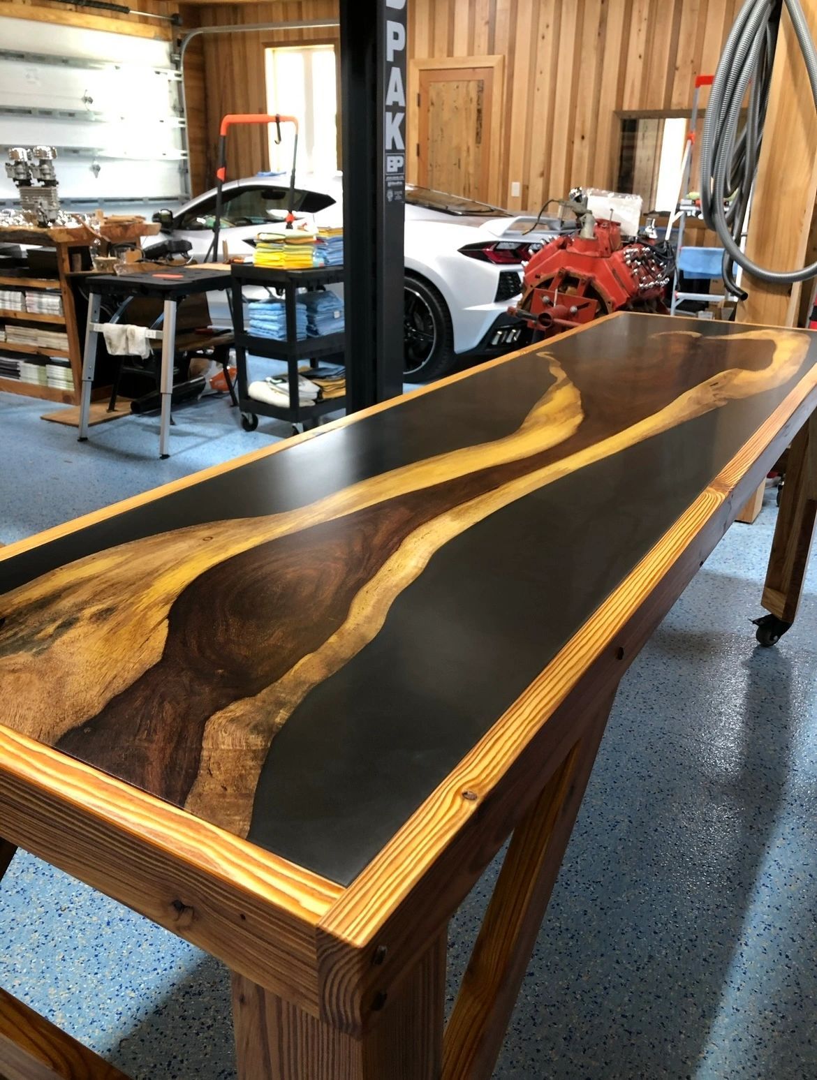 Walnut river table with black resin river on a timber frame